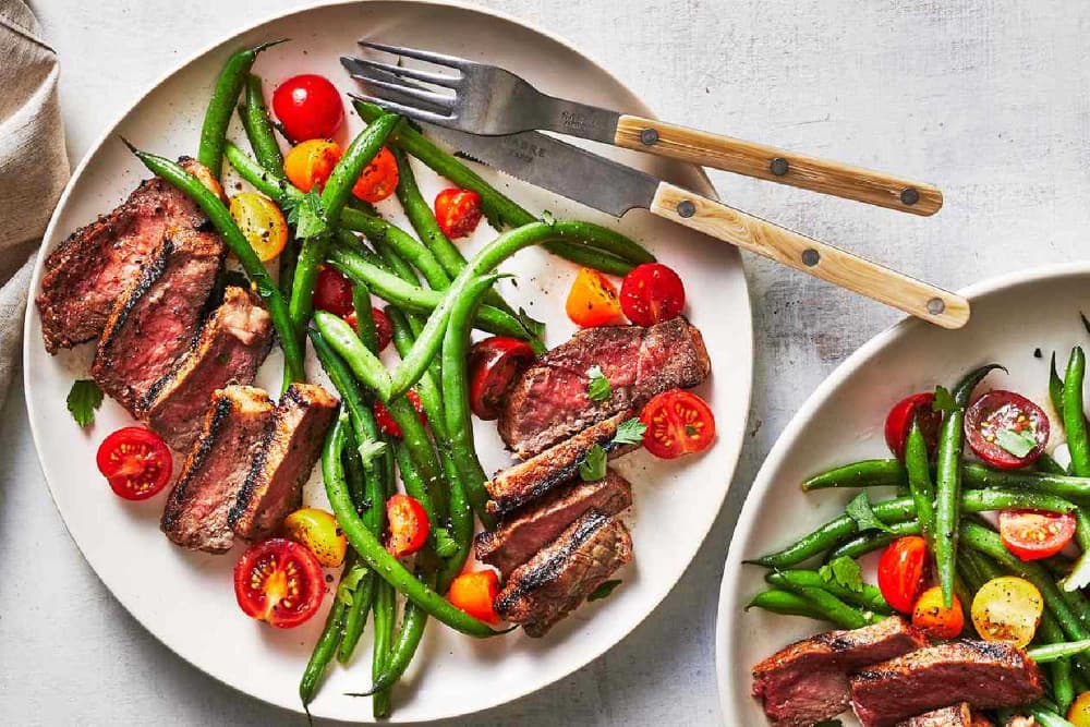 A plate with a steak dinner and fresh veggies