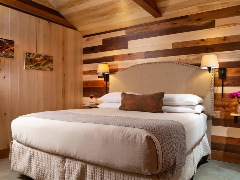Warm and inviting basswood bedroom with king-size bed inside Sunrise Cottage.